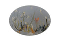 An oval hand-painted canvas wall art piece featuring an abstract floral design in muted blue-gray, white, yellow, orange, and brown tones, mounted on a textured off-white wall.