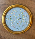 Encore framed round original artwork on wood floor